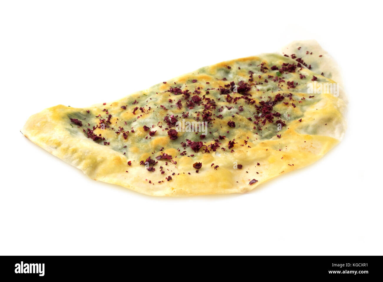 Azerbaijani Yashil Qutab (rolled dough filled with greens) with Sumac on a white background Stock Photo
