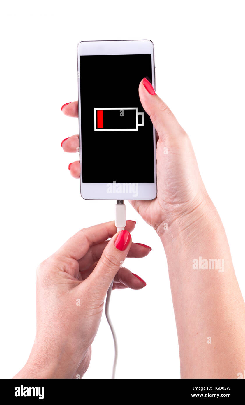 Female hand holding low battery smartphone and connect charger isolated on white background