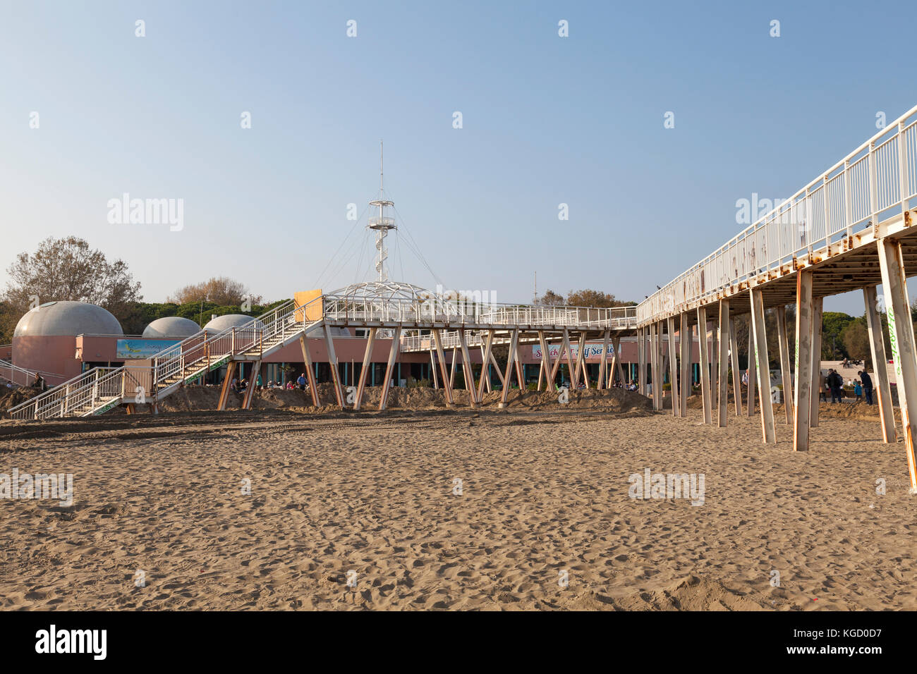 Blue Moon Beach , Lido di Venezia, Lido, Venice, Italy with a view of the old historic metal pier complex with its observation mast at sunset Stock Photo