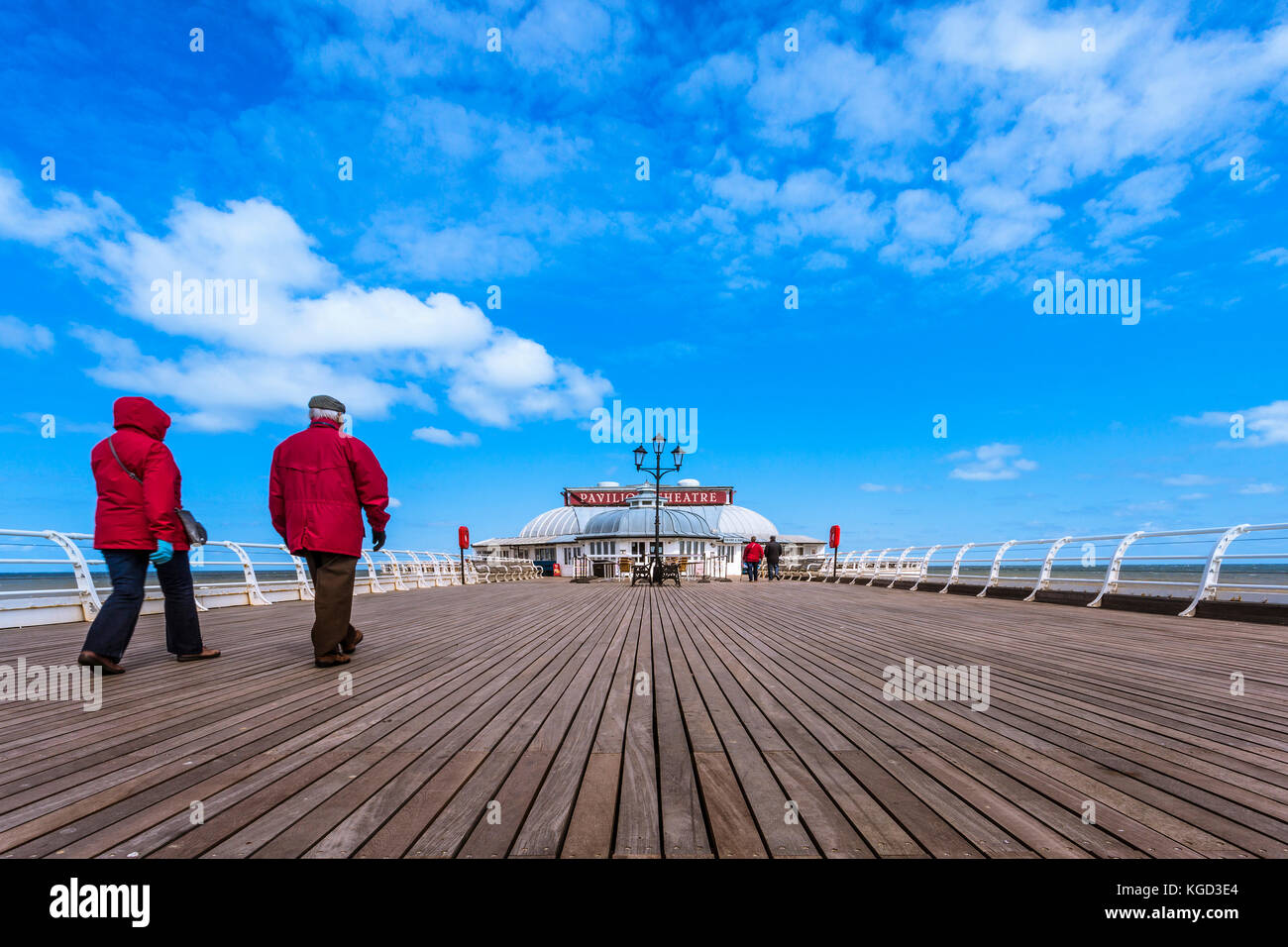 Walking along Cromer pier towards the Pavilion theatre. Stock Photo