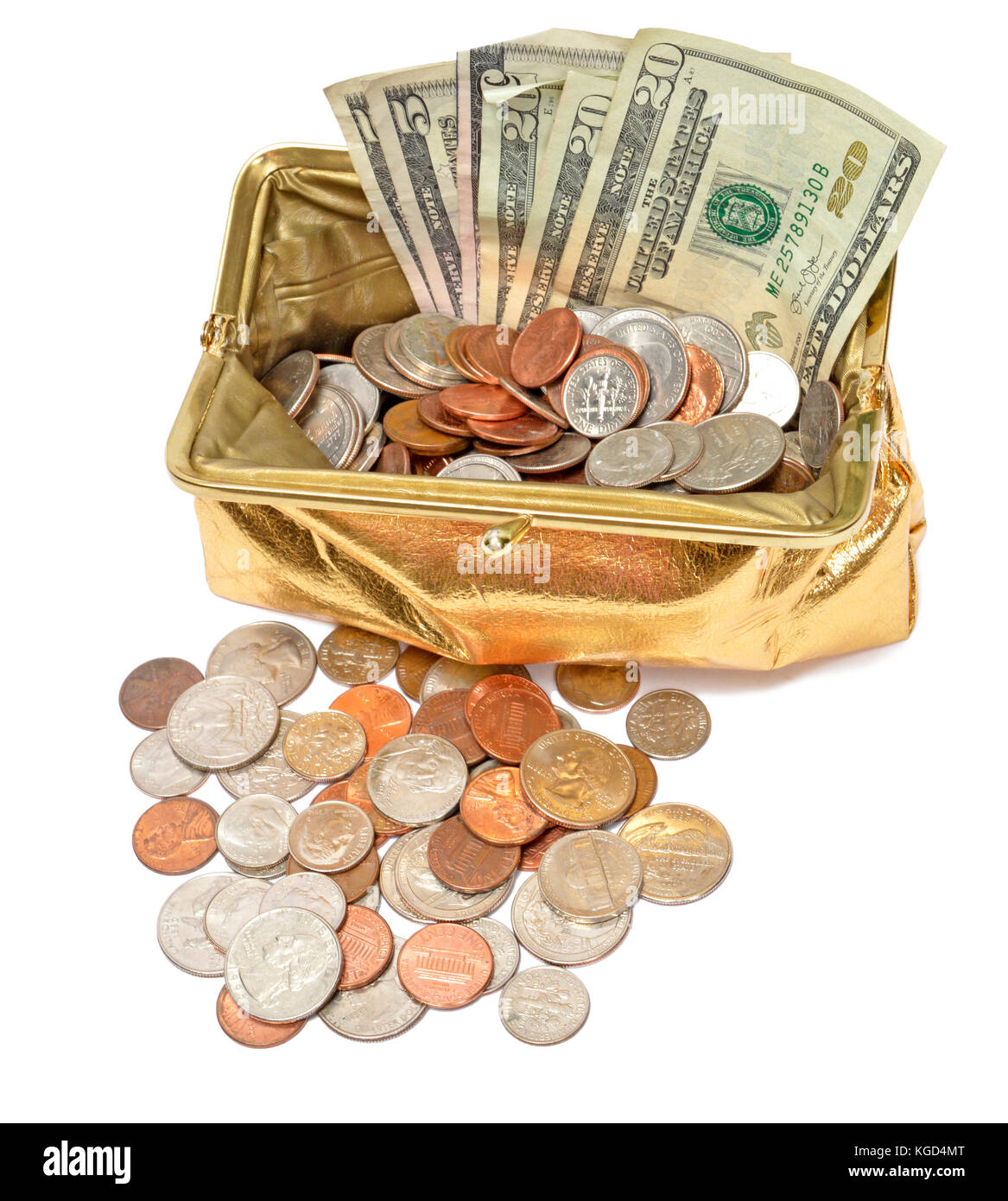 Vertical shot looking down on a gold metallic coin purse filled with five and twenty dollar bills and coins.  There are also coins in front. Stock Photo