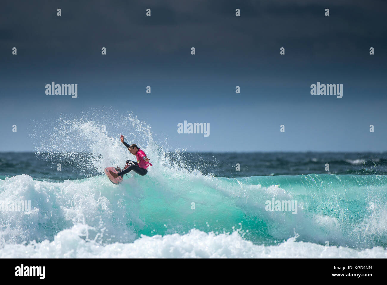 A young male surfer competing in the UK Schools Surf Championship at Fistral in Newquay. Stock Photo