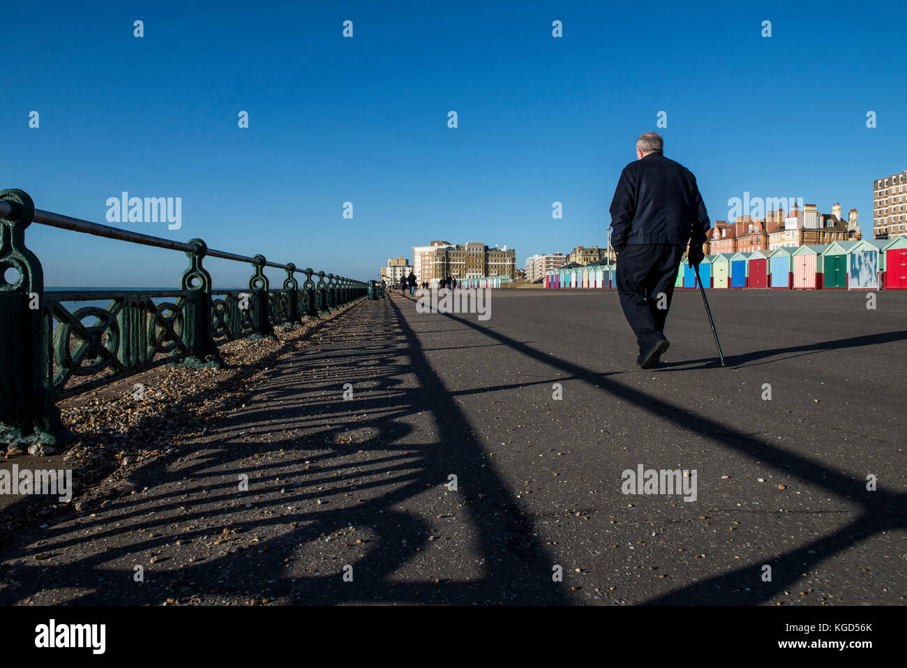 Man walking by the seafront promenade in Hove Stock Photo - Alamy
