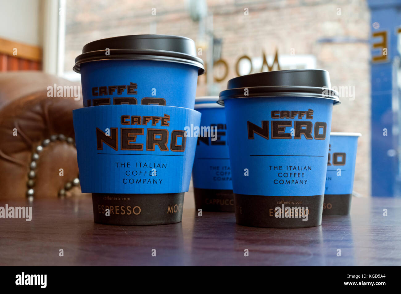 Caffe Nero disposable cups on table. Stock Photo