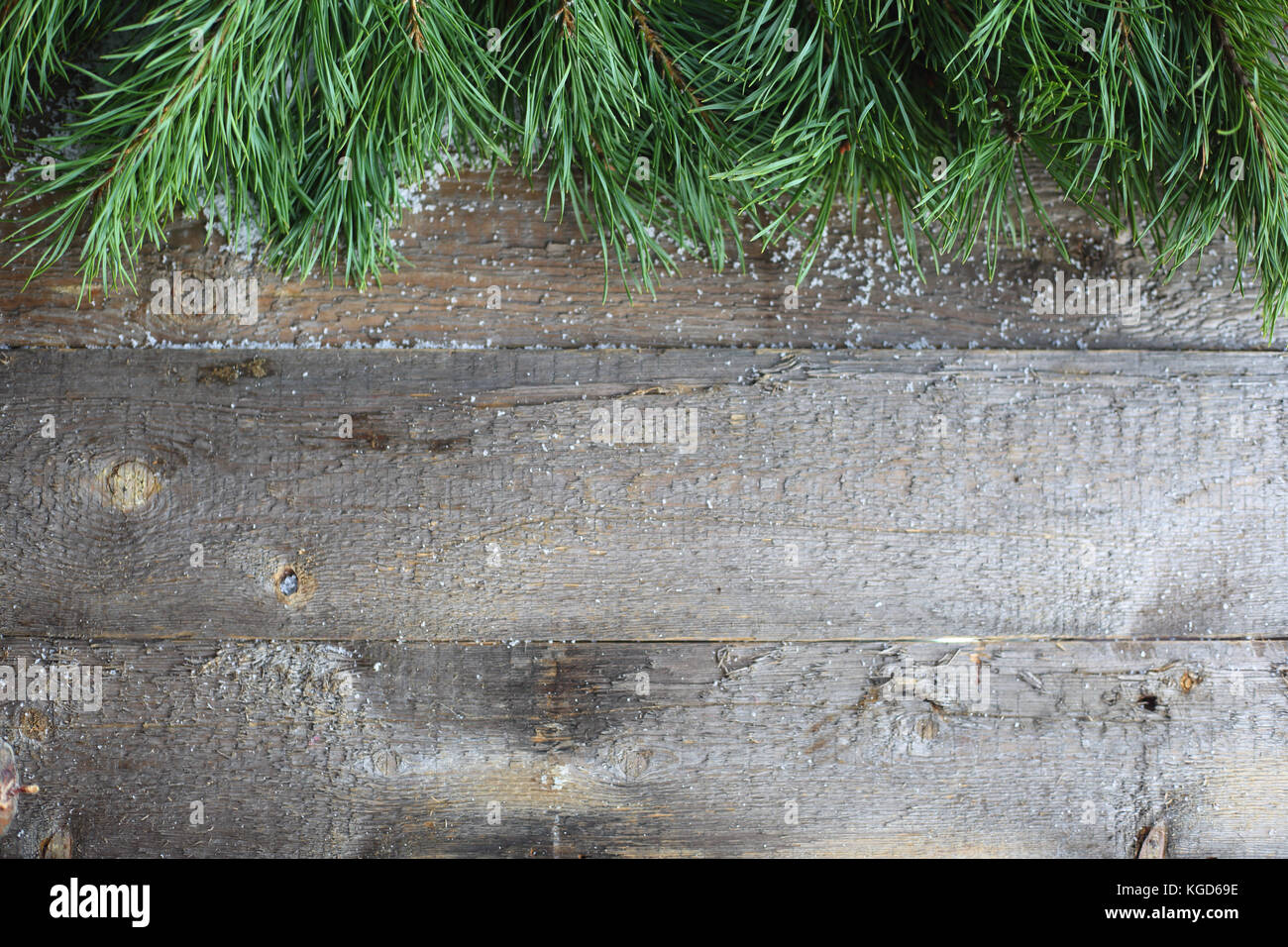 Christmas card on wooden background with snow and fir tree branch. View ...