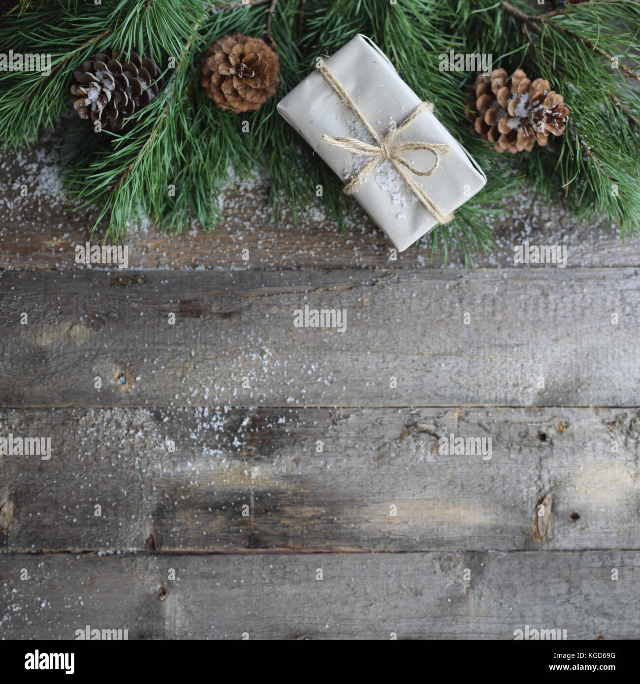 Christmas card on wooden background with snow and fir tree branch with ...