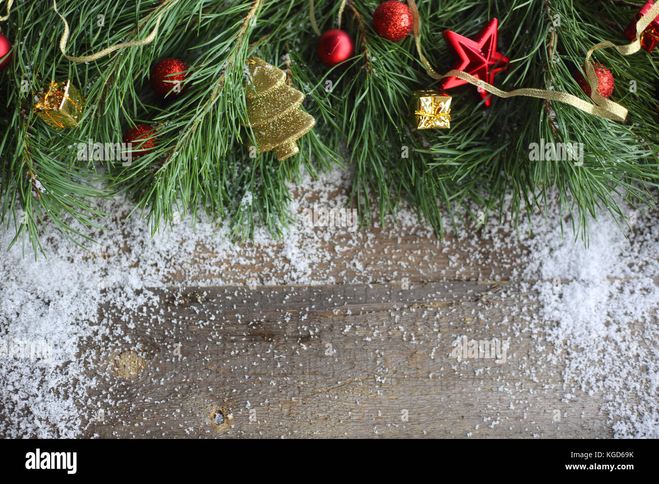 Christmas card on wooden background with snow fir tree and decoration ...
