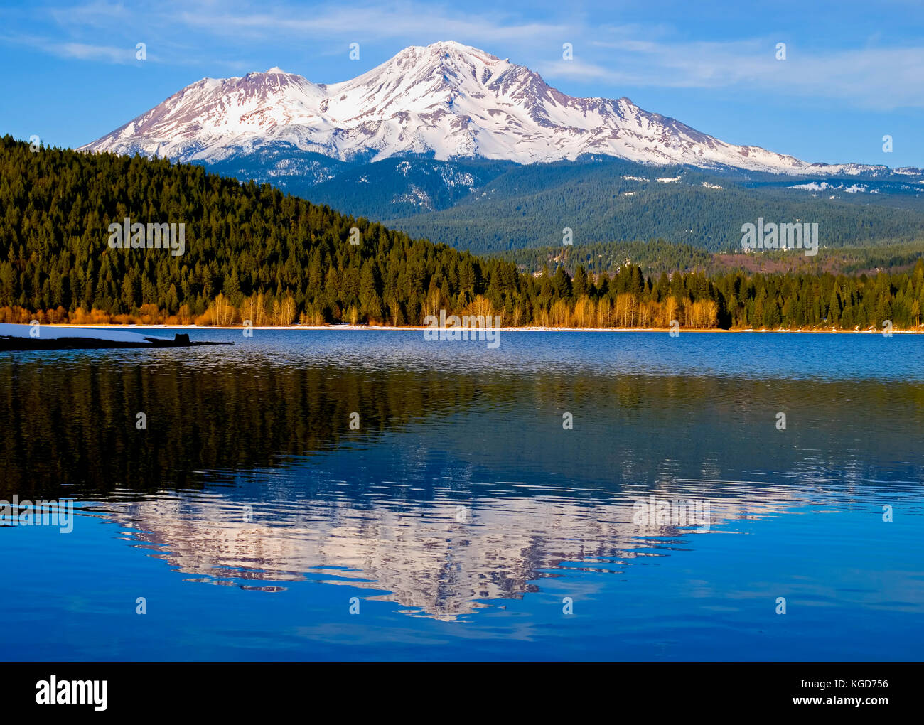 Mount Shasta in winter with lake on foreground Stock Photo