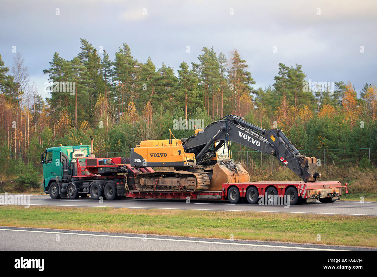 PAIMIO, FINLAND - OCTOBER 23, 2015: Volvo FH truck hauls Volvo EC460 BLC hydraulic crawler excavator. The excavator weighs 46 tonnes. Stock Photo