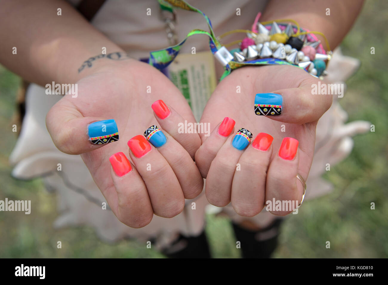 Young woman with painted nails ready at Glastonbury Festival Glastonbury festival 2013 Stock