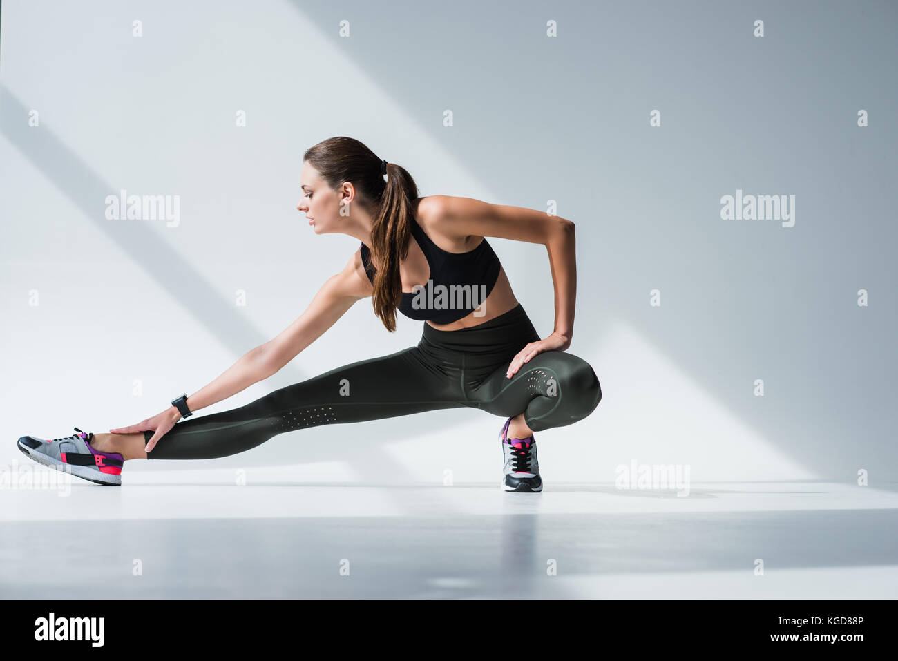 sporty woman stretching legs Stock Photo - Alamy