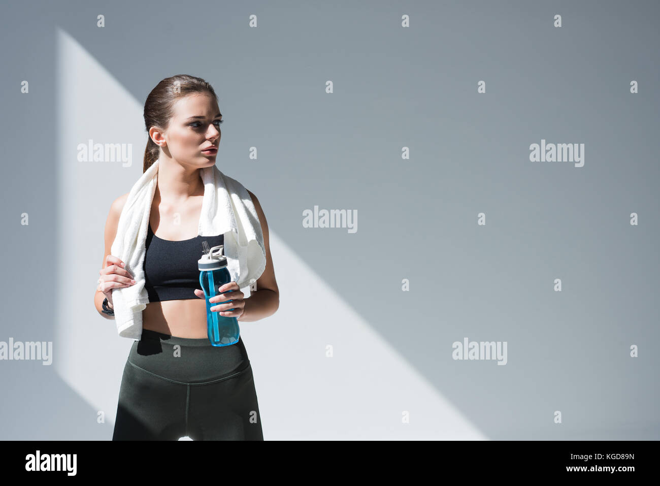 sportswoman with towel and bottle of water Stock Photo - Alamy