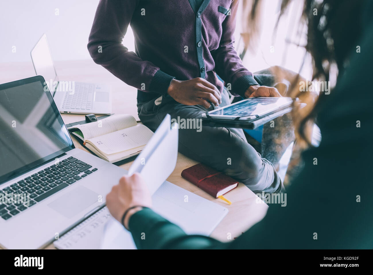 Middle section of contemporary multiethnic business people working ...