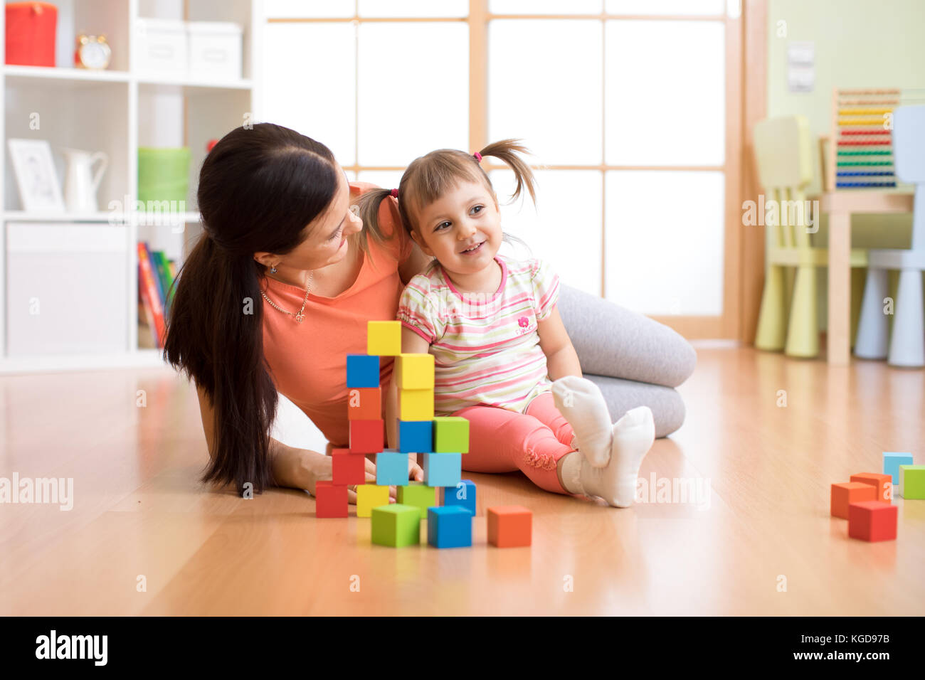 cute mother and child girl play with cubes together Stock Photo