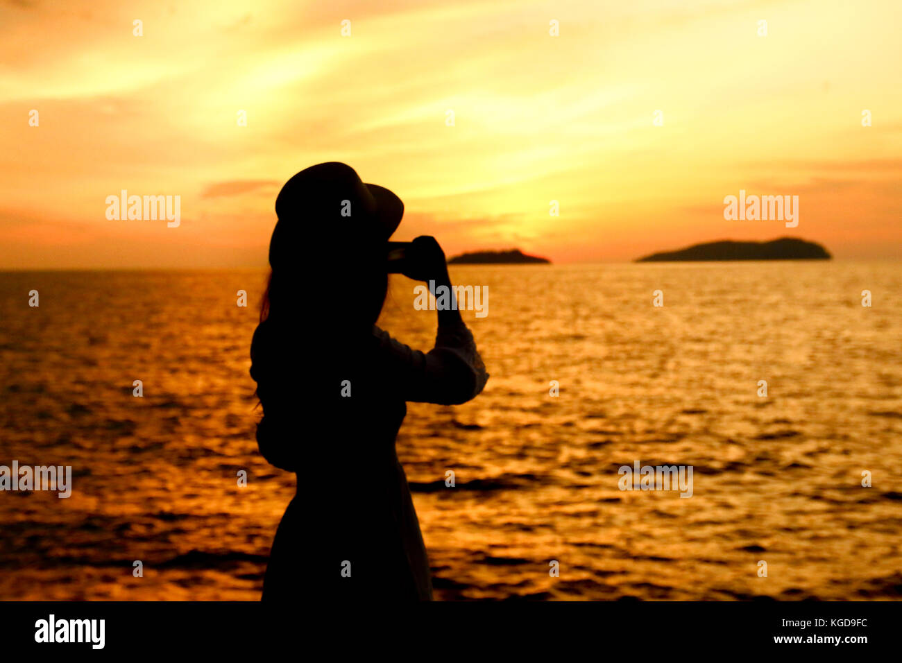 silhouette of a woman under beautiful sunset Stock Photo - Alamy