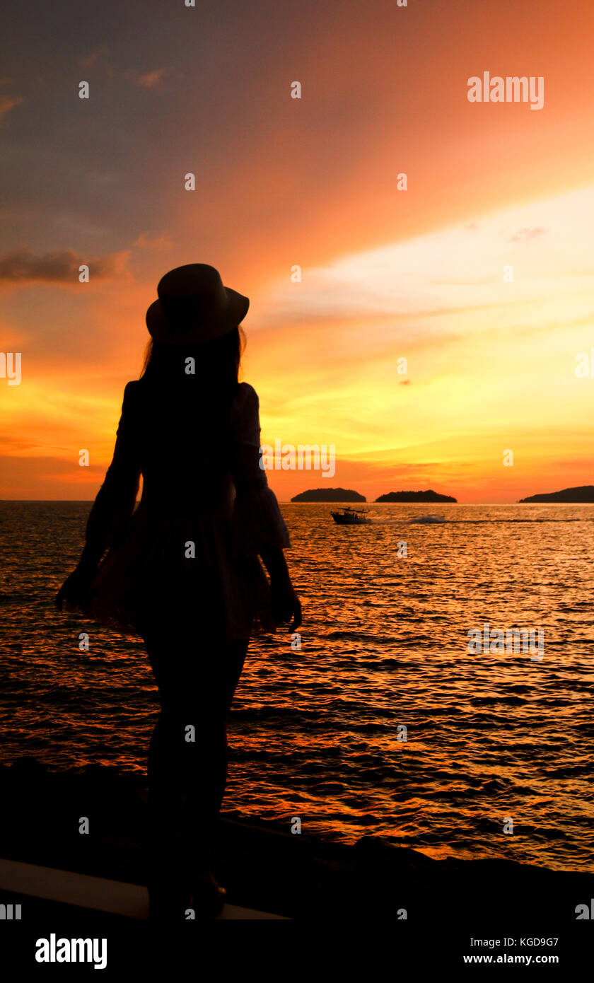 silhouette of a woman under beautiful sunset Stock Photo - Alamy