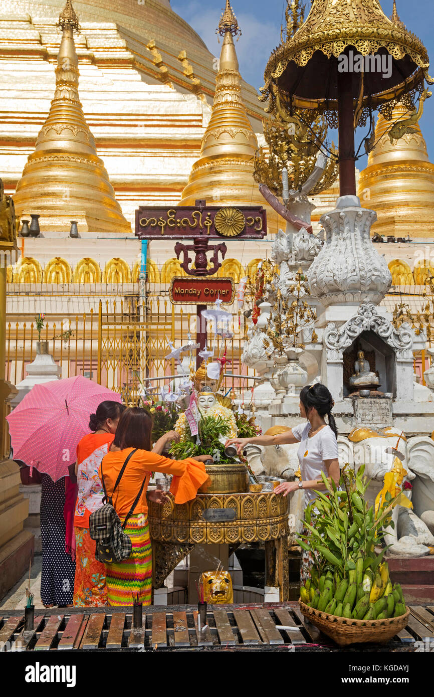 Burmese visitors at the Monday planetary post at the Shwedagon Pagoda / Golden Pagoda in Yangon, Myanmar in Yangon / Rangoon, Myanmar / Burma Stock Photo