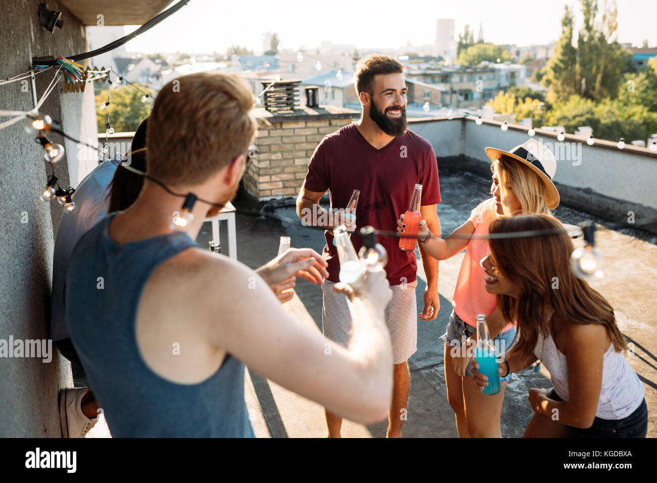 Group of happy friends having party on rooftop Stock Photo - Alamy