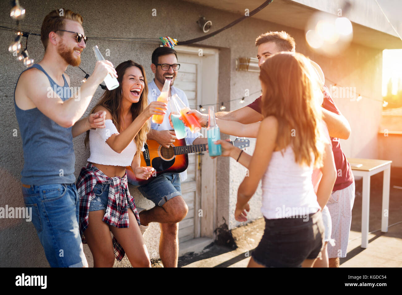 Group of happy friends having party on rooftop Stock Photo