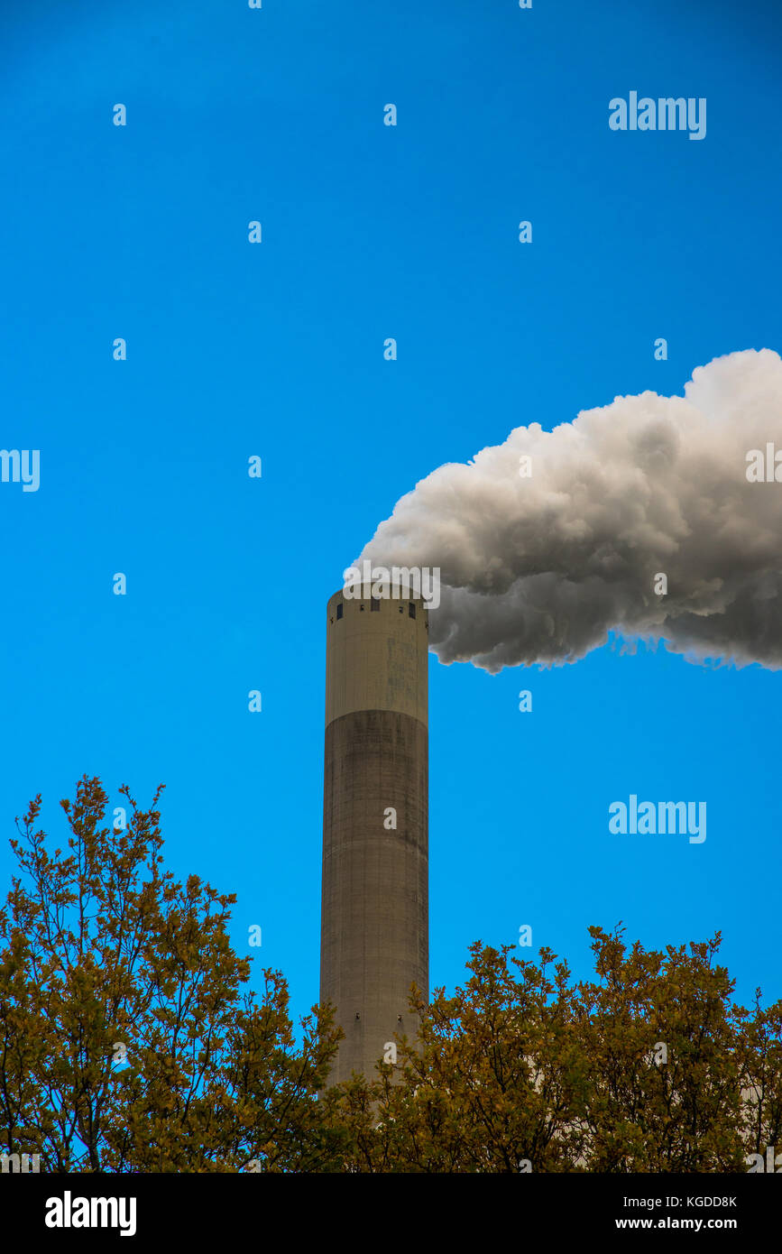 chimney from powerplant with white smoke and blue sky Stock Photo