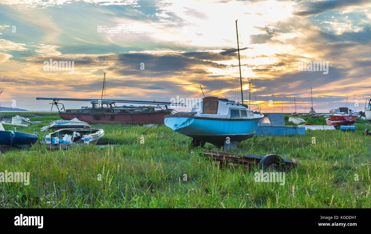 A group of boats on the river dee estuary at sunset Stock Photo