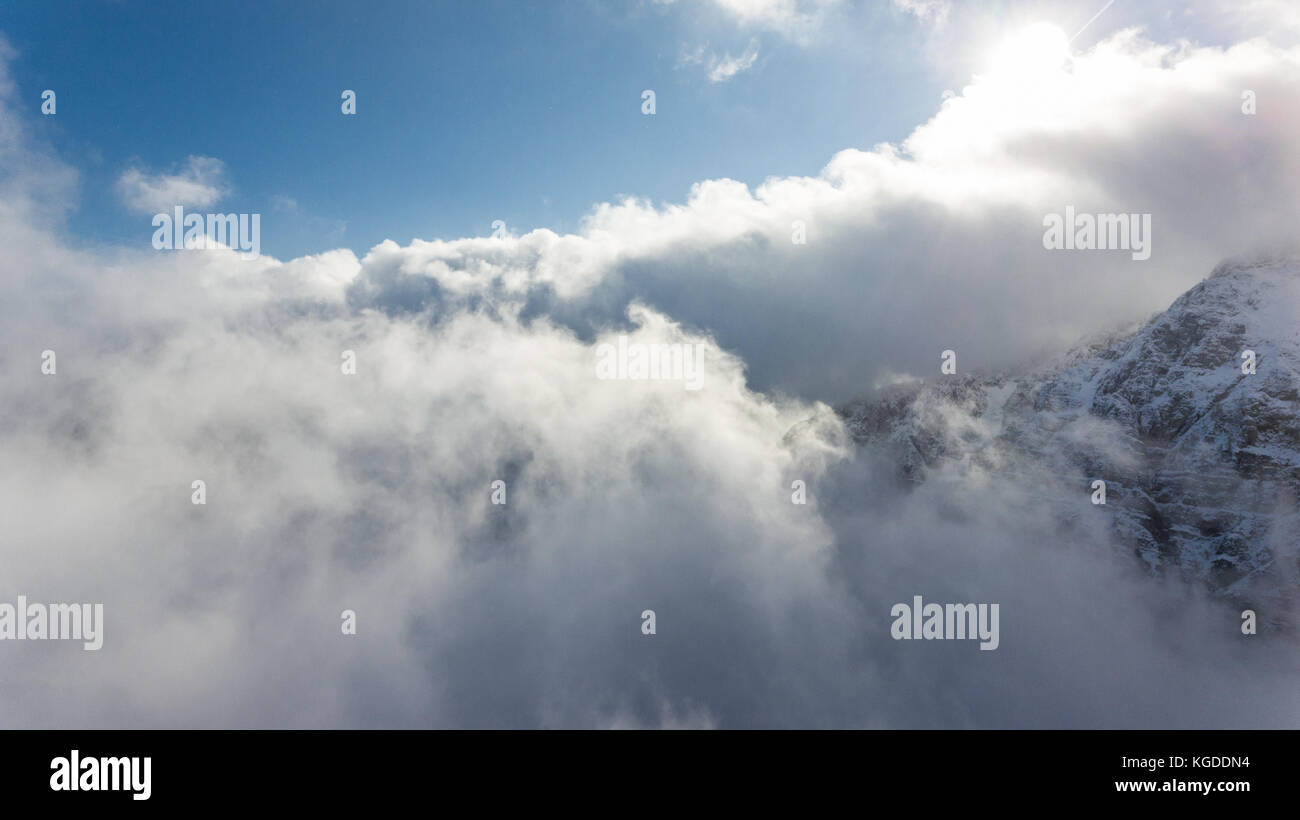 Cloud On Ridges Aerial view of clouds circling around mountain ridge Stock Photo - Alamy