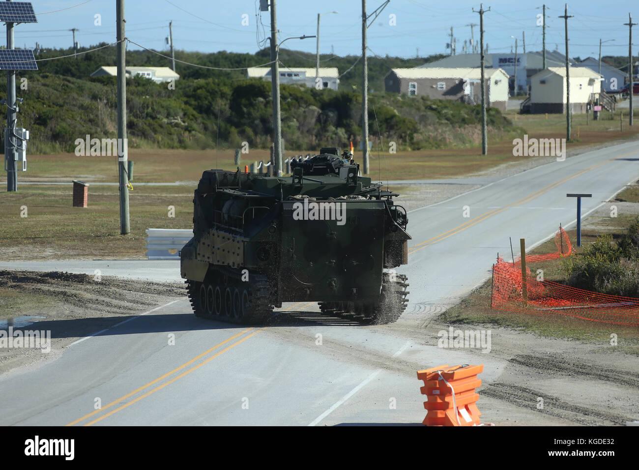 An AAV-P7/A1 assault amphibious vehicle (AAV) crosses the road to await the arrival of other AAVs during a training exercise at Camp Lejeune, N.C., Oc Stock Photo
