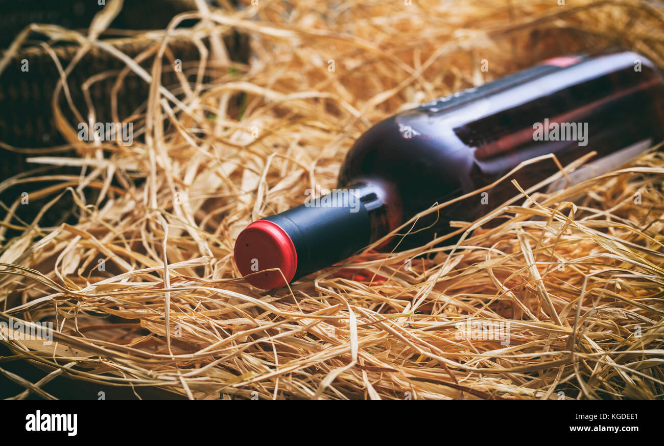 Unopened rose wine bottle on straw background Stock Photo Alamy