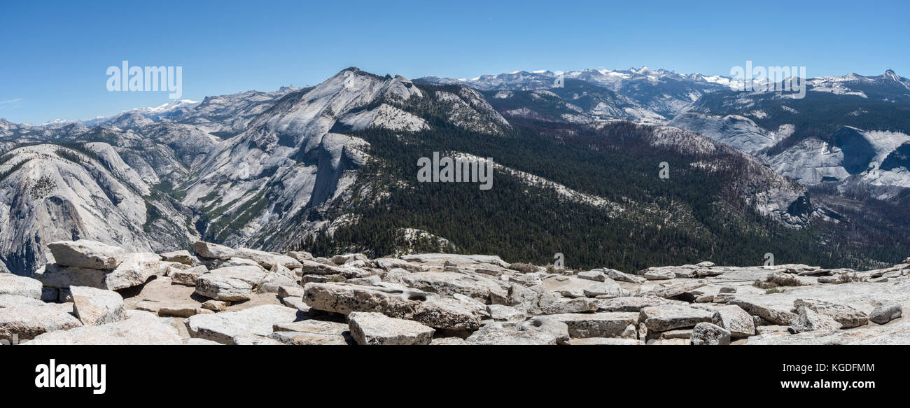 A view of the Sierra Nevada mountain range from the top of Half Dome in Yosemite National Park. Stock Photo