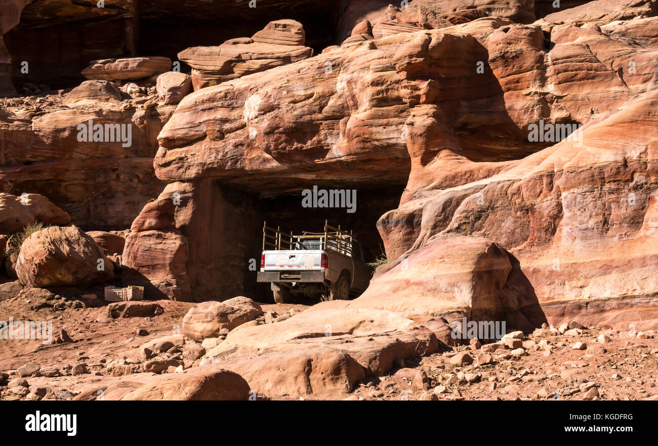 Juxtaposition of 4 wheel drive vehicle parked in old carved Nabataean tomb, Petra, Jordan, Middle East Stock Photo