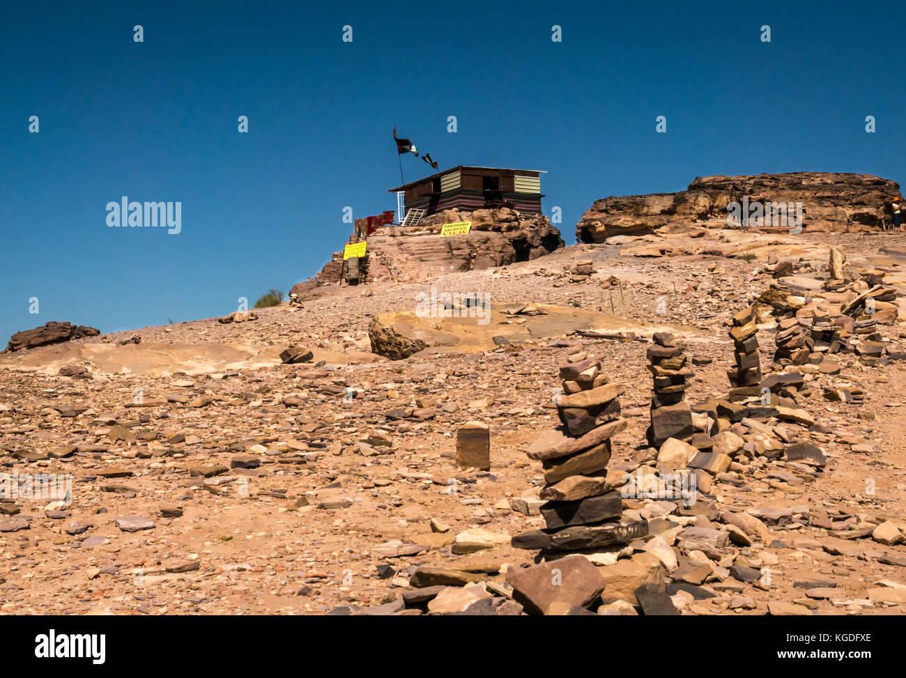 Sandy path lined with inukshuks or stone cairns leading to mountain top hut, Ad Deir, Petra, Jordan, Middle East Stock Photo