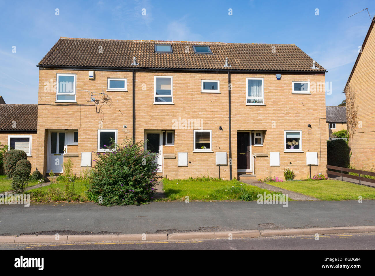 Newly built two floors semi detached council houses with small garden in the front on an empty street in England, UK Stock Photo