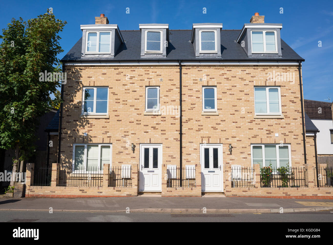 Newly built three floor semi detached houses on an empty street in England, UK Stock Photo