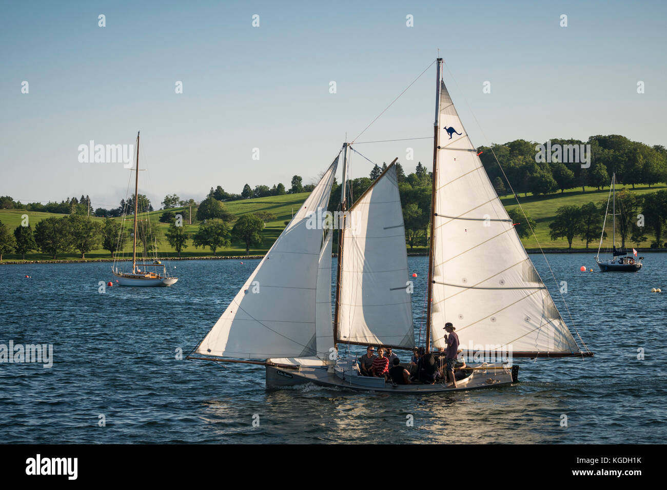 A small open schooner sailing in the harbour at Lunenburg, Nova Scotia