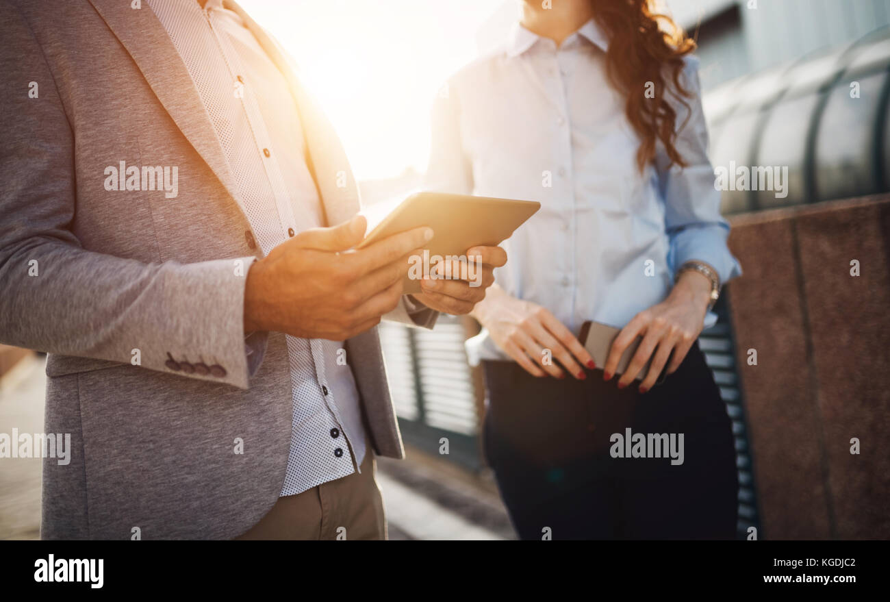 Young business couple walking outdoor near office building Stock Photo ...