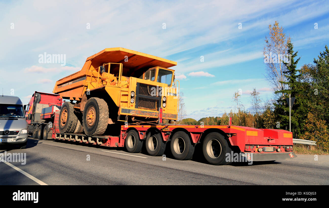 PARAINEN, FINLAND - OCTOBER 9, 2015: Volvo FH hauls a Volvo BM 540 Rigid dump truck as wide load. The BM 540 was designed a cost-effective load carrie Stock Photo