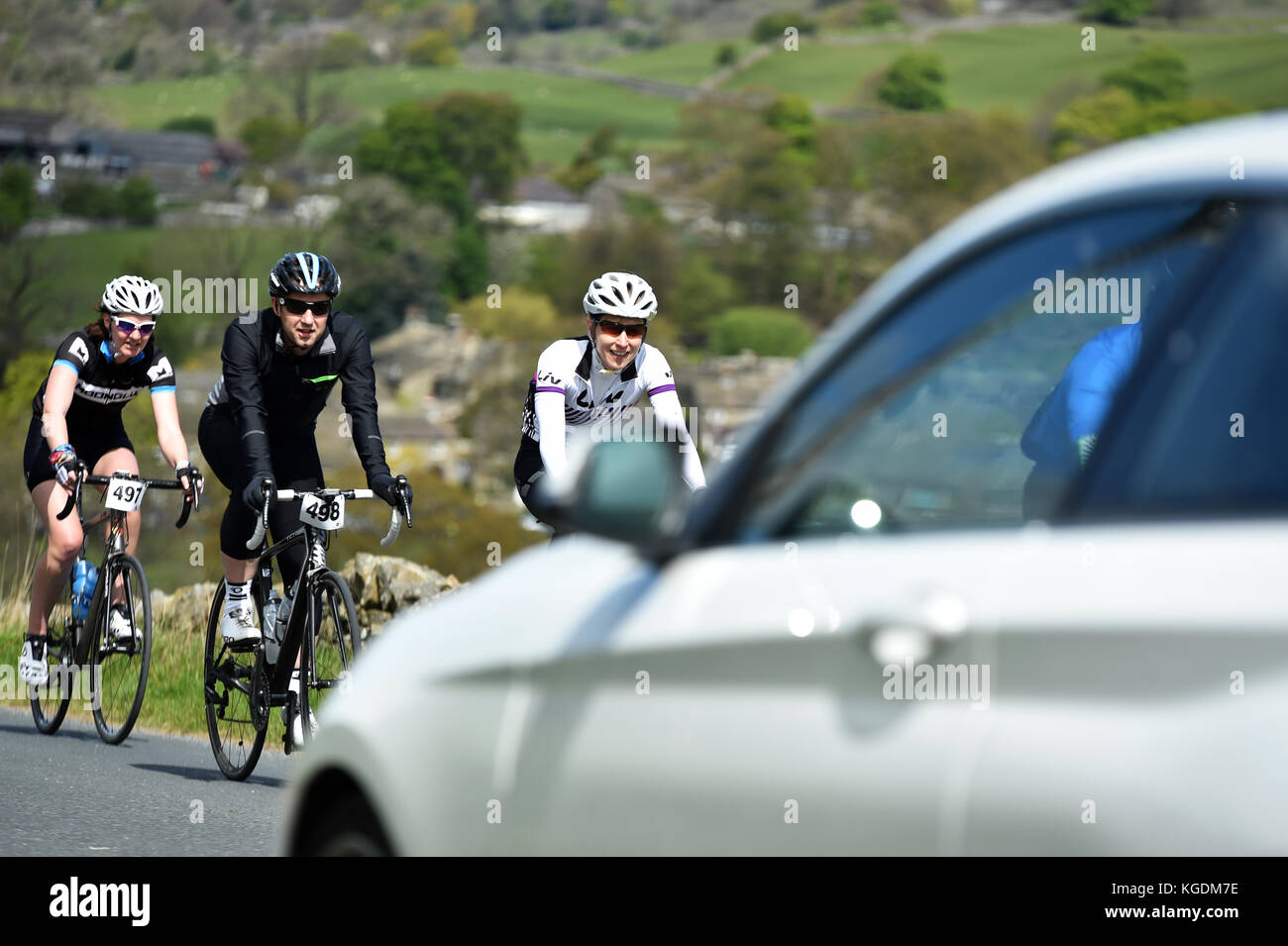 Group of cyclists sharing the road with cars Stock Photo