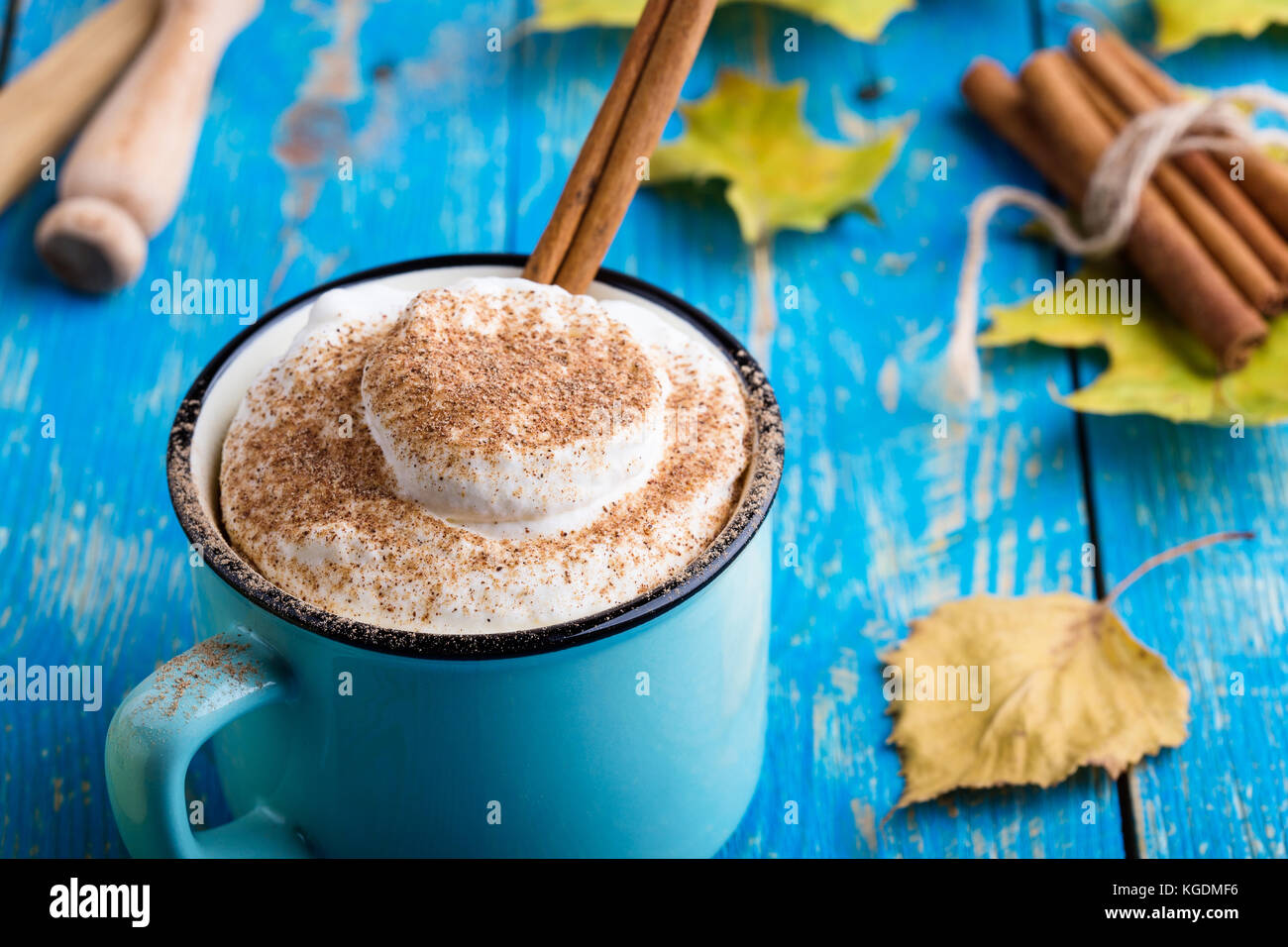 Pumpkin spice latte with whipped cream and cinnamon in rustic mug on ...
