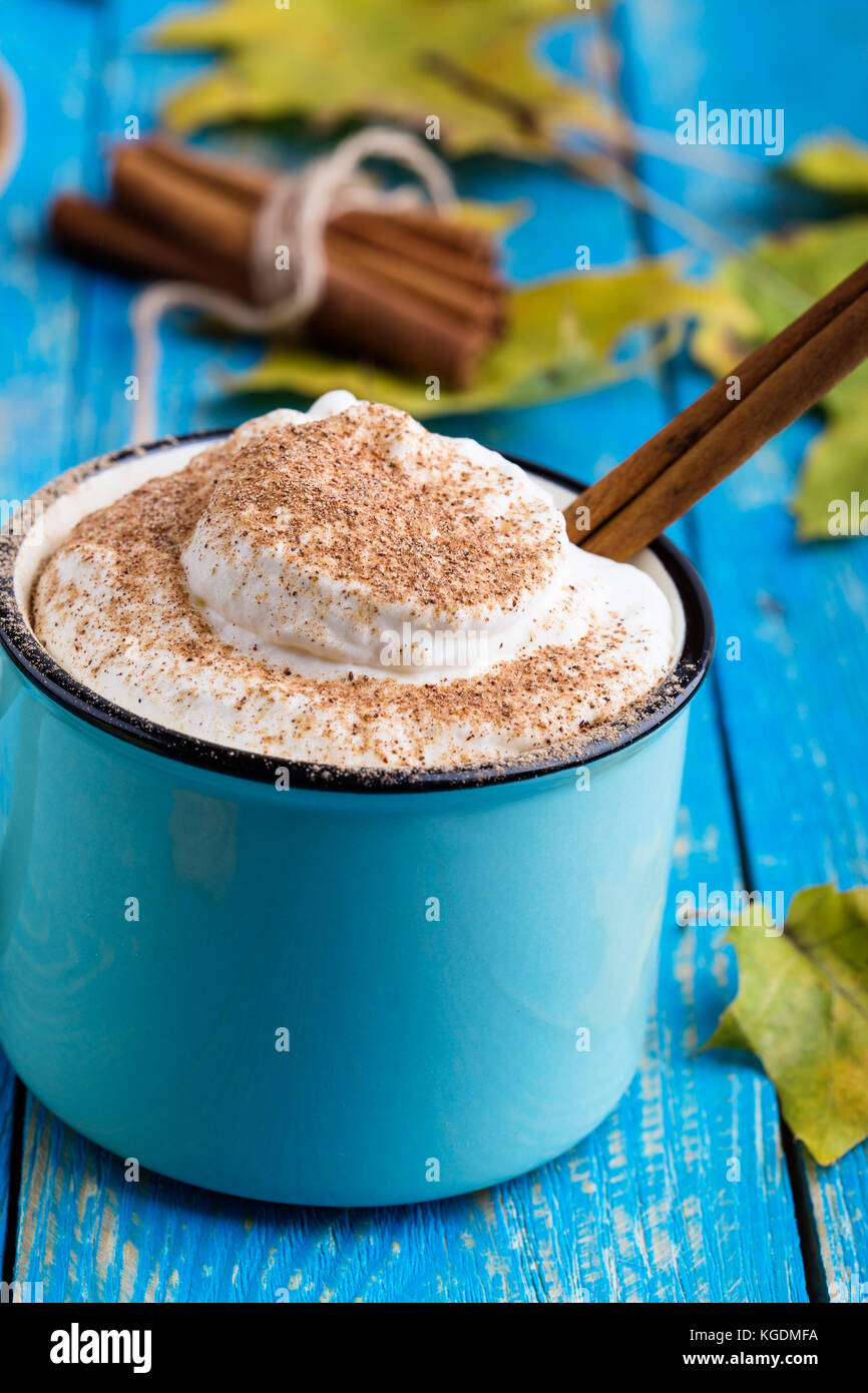 Pumpkin spice latte with whipped cream and cinnamon in rustic mug on ...