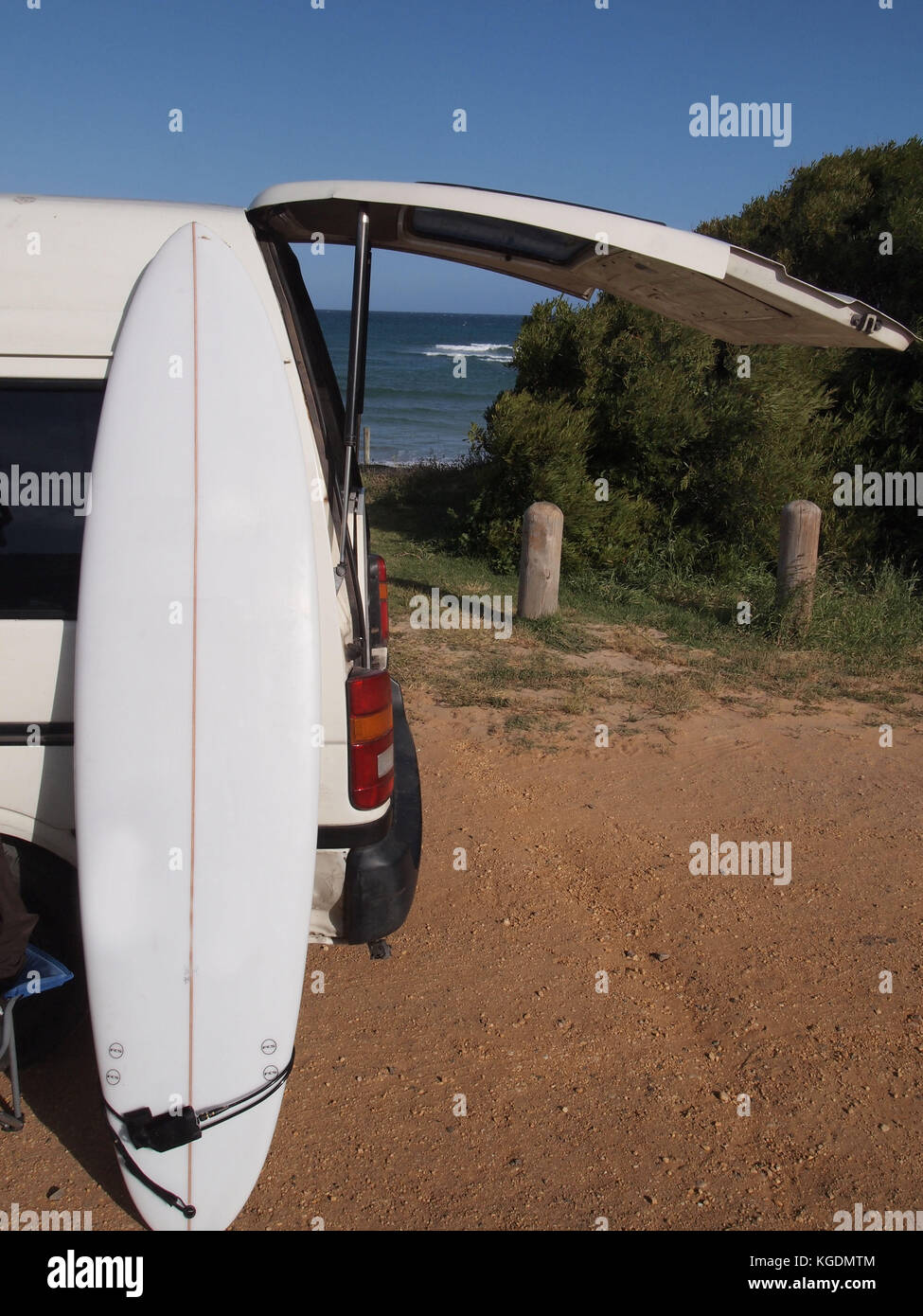 Surfboard in front of a Campervan Stock Photo