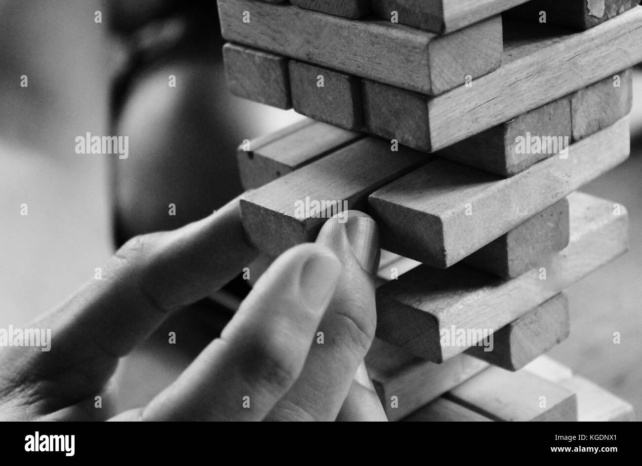 jenga tower wooden blocks game hand pulls block with care physical