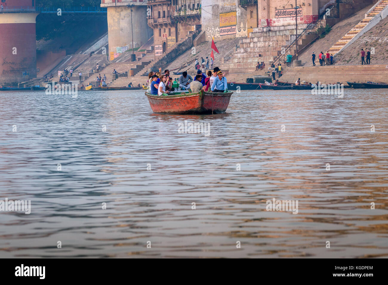 Tourists enjoying early morning boat riding on the River Ganges at Varanasi,Uttar Pradesh,India. Stock Photo
