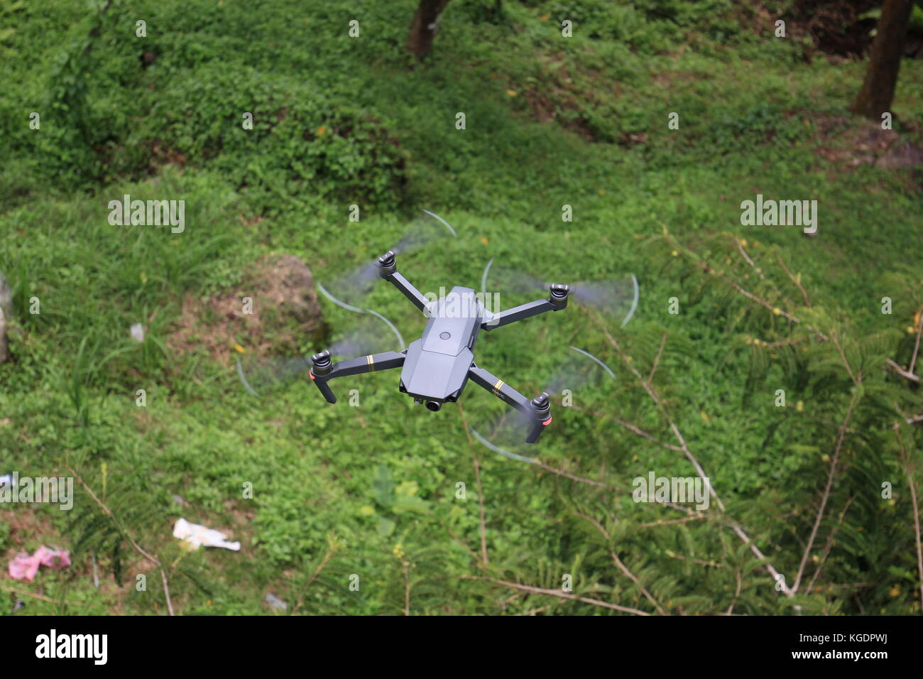 Flying the drone to explore into the wilds. Stock Photo