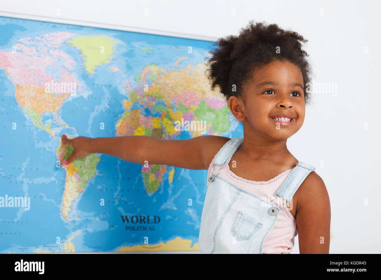 African american preschool girl in classroom with world map Stock Photo