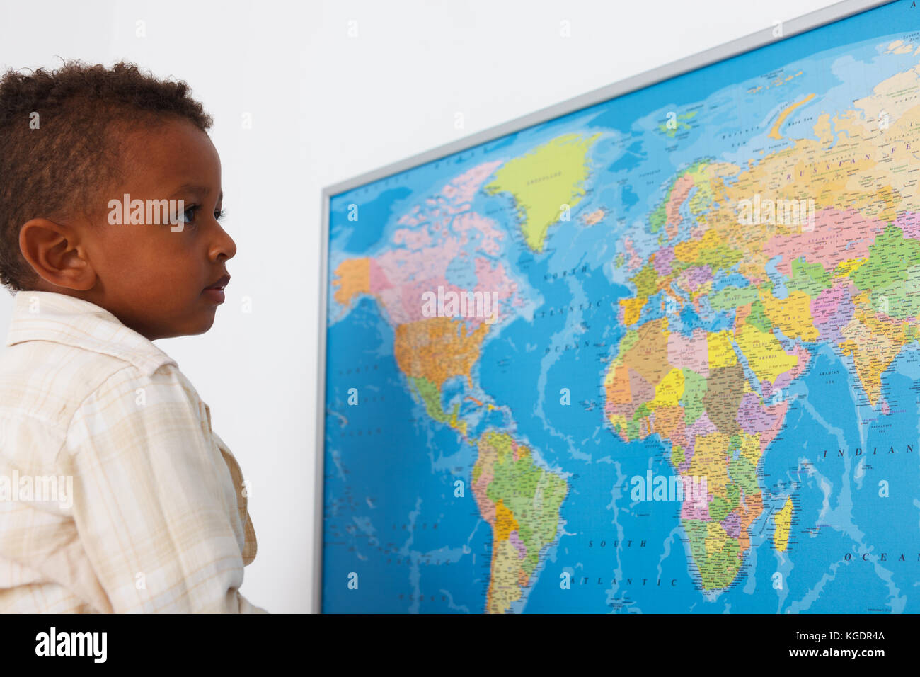African american preschool boy in classroom with world map Stock Photo
