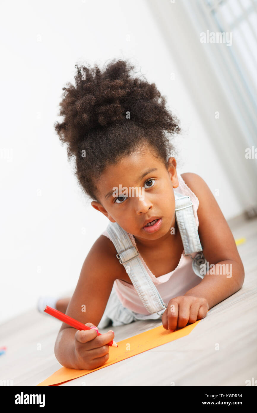 Preschool child girl drawing on the floor Stock Photo