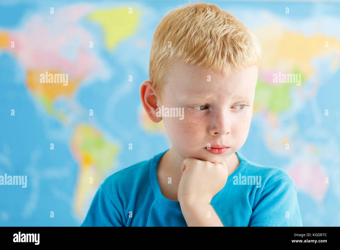 Child think about the world near the map Stock Photo