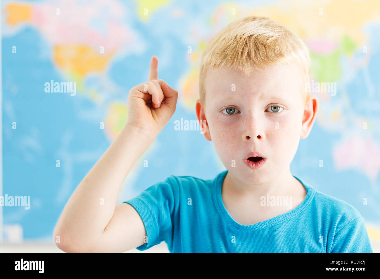 Surprised student raised his finger on geography lesson Stock Photo