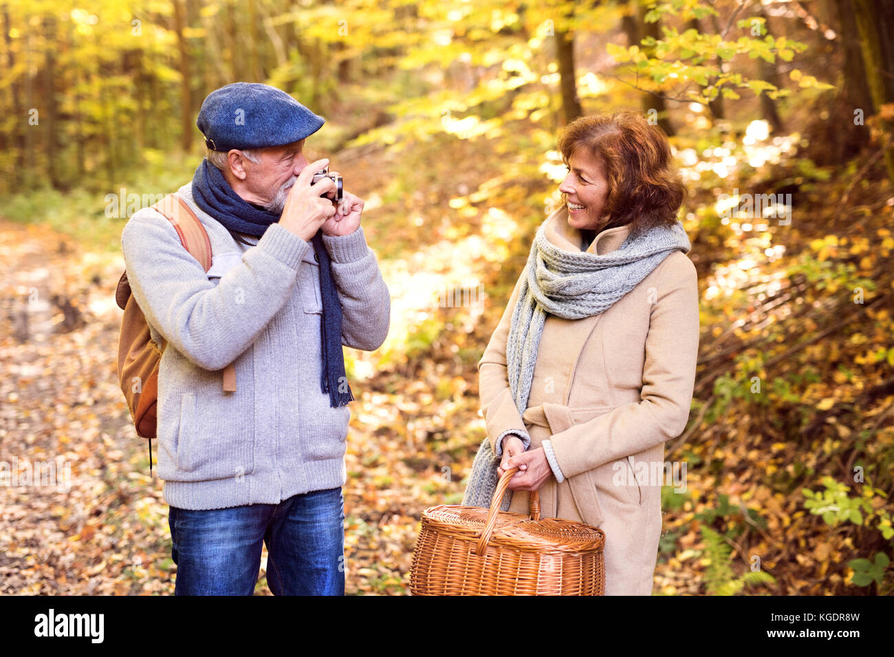 Senior couple on a walk in autumn forest Stock Photo - Alamy