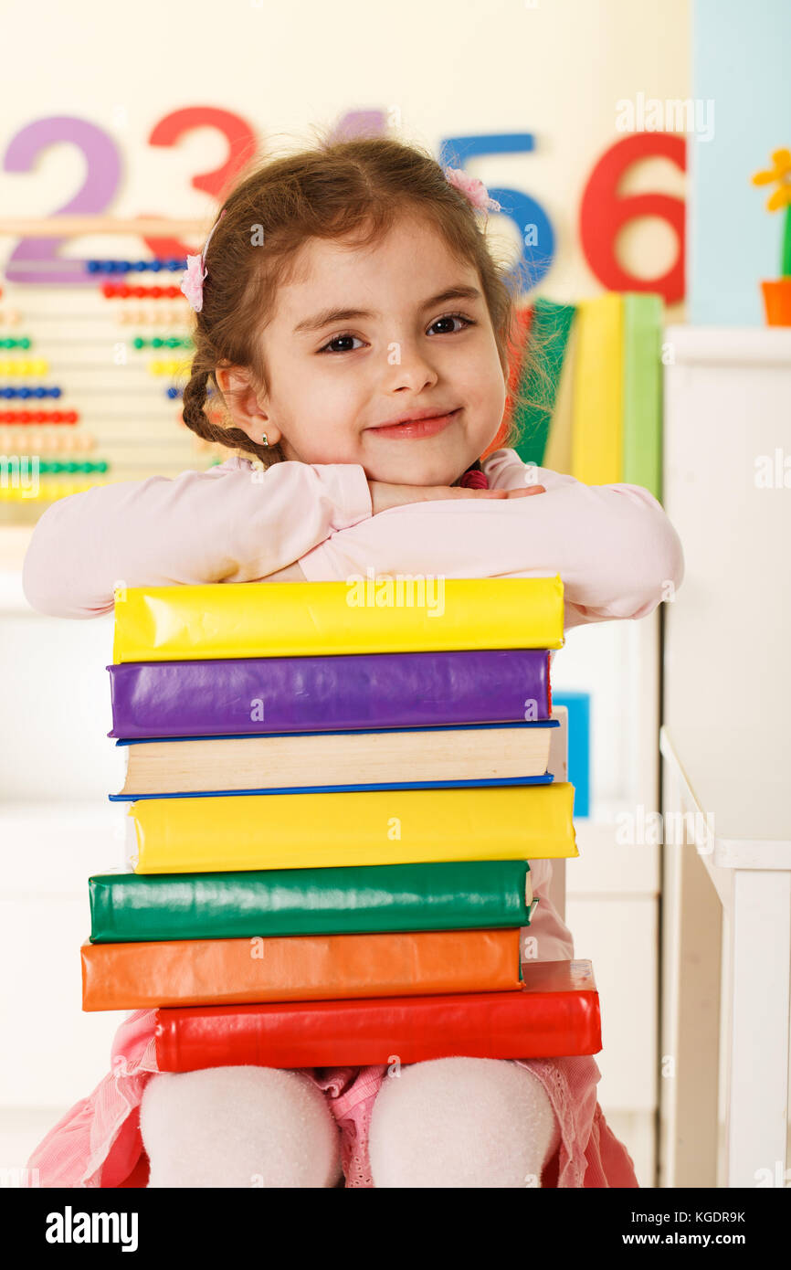 Preschool girl with a books Stock Photo - Alamy
